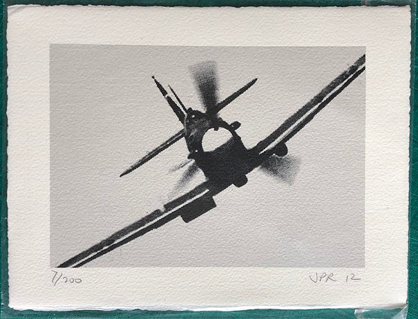 Spitfire comes at you head-on. On silver background.