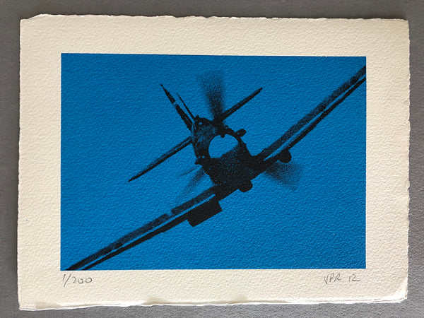 The Spitfire banks in a clear blue sky